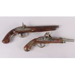 A reproduction flintlock pistol and another similar