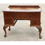 A walnut bowfront desk, fitted one long and two deep drawers, on carved cabriole claw and ball