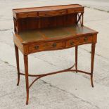 A yew wood and banded writing desk with drawers over tooled writing surface, 36" wide x 40" high x