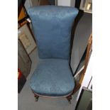 A 19th century walnut prie-dieu, upholstered in blue floral fabric, on cabriole supports
