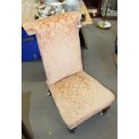 A late 19th century prie-dieu, upholstered in a pink floral fabric, on turned and castored supports