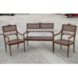 An Edwardian carved frame cane seat and back settee and matching armchairs