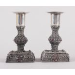 A pair of Continental white metal filigree and garnet mounted candlesticks, 4 1/2" high