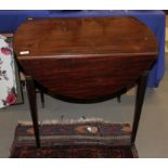 An early 19th century mahogany oval Pembroke table, fitted one drawer with brass handles, on