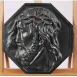 An Art Deco octagonal bronze relief cast bust of Christ, 9 1/2" wide