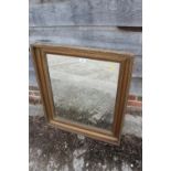 A rectangular gilt framed wall mirror with moulded decoration, plate 23" x 19"