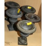 Five matched cast metal campana urns, on square bases, 5" high