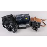 A Nikon Coolpix P500 camera, a Panasonic Lumix FX55 camera and a Kodak Six-20 Junior De Luxe