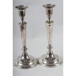 A pair of filled silver candlesticks, 12" high