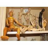 A quantity of wooden mannequins and two adjustable wooden models hands