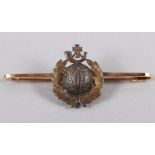 A yellow metal bar brooch, stamped 15ct, with Royal Marines insignia, 4.6g