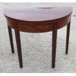 A 19th century semicircular mahogany fold-over top card table, on square taper supports, 36" wide