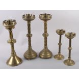 Two pairs of brass Gothic design candlesticks and one other