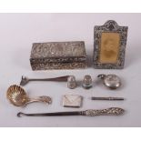 A Georgian design silver shell-bowl caddy spoon, a silver sovereign case, a silver envelope stamp
