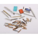 A number of propelling pencils, dip pen nibs, pencil lead cases and other writing accessories