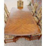 An oak banded extending dining table with two extra leaves, on twin pedestal supports, 39 1/2"