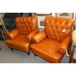 **A pair of brown leather button back armchairs, on turned supports (**Please note this lot is