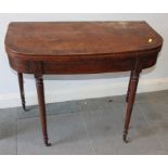 A late Georgian mahogany and rosewood banded fold-over top 'D' shape tea table, on turned and