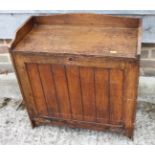 A late 19th century oak fall front writing cabinet with baize-lined slope, drawers and pigeon holes,