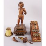 An early 18th century Continental carved wood bracket with figure of Christ child holding a globe,