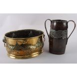 An Art Nouveau hammered copper and pewter inlaid two handled vase, 10 3/8? high, and a brass oval