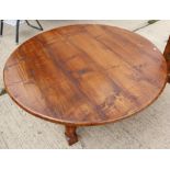 An oak circular low coffee table, on turned and stretchered supports, 48" dia x 19 1/2" high