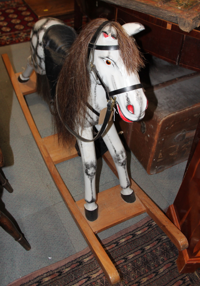 A grey painted rocking horse, 62" wide