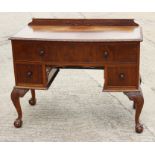 A walnut bowfront desk, fitted one long and two deep drawers, on carved cabriole claw and ball