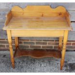 A waxed pine tray top washstand, on turned supports united by an undertier, 35" wide x 18" deep x