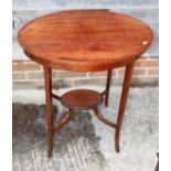 An Edwardian mahogany string inlaid oval two-tier occasional table, on quadruple splay supports,