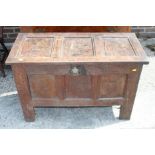 An 18th century oak three-panel front coffer chest with lunette carved top rail retaining hinges,