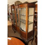 A late 19th century walnut double bowfront display cabinet enclosed leaded glazed doors, on cabriole