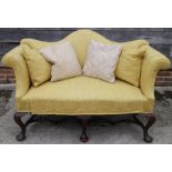 A two seat settee of mid 18th century design, upholstered in an old gold brocade, on cabriole and