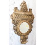 A gilt framed circular mirror, decorated flowers and scrolls, 6 3/4" dia