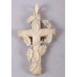A 19th century Dieppe carved ivory crucifix with holly leaves, 3" high overall