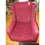 A 19th century low seat square armchair, on castored supports