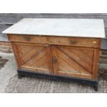 A 19th century Aesthetic oak and inlaid marble top sideboard, fitted two drawers and cupboards, on