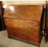 A Georgian mahogany fall front bureau with interior fitted pigeonholes and central cupboard over