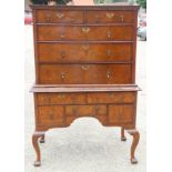 An early 18th century burr walnut chest on stand, the upper section with two short and three long