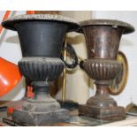 Two cast metal campana urns, on square bases, 11" high