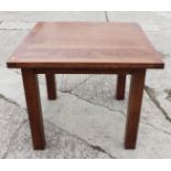 An oak fold-over top dining table, on square supports, 71" wide when open, and four hand carved