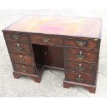 A late 19th century mahogany double pedestal kneehole desk with tool lined top over nine drawers