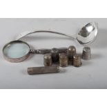 A silver sauce ladle, 1.9oz troy approx, six silver thimbles, a silver pill box, 1.1oz troy approx