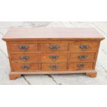 An Oriental hardwood chest of nine drawers with heavy brass handles, on bracket feet, 71" wide x 21"