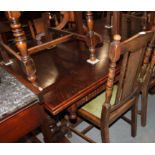 An oak draw leaf extending dining table of 17th century design, on cup and cover turned supports,