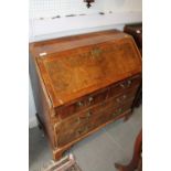 A George III walnut and banded fall front bureau with fitted interior over two short and two long