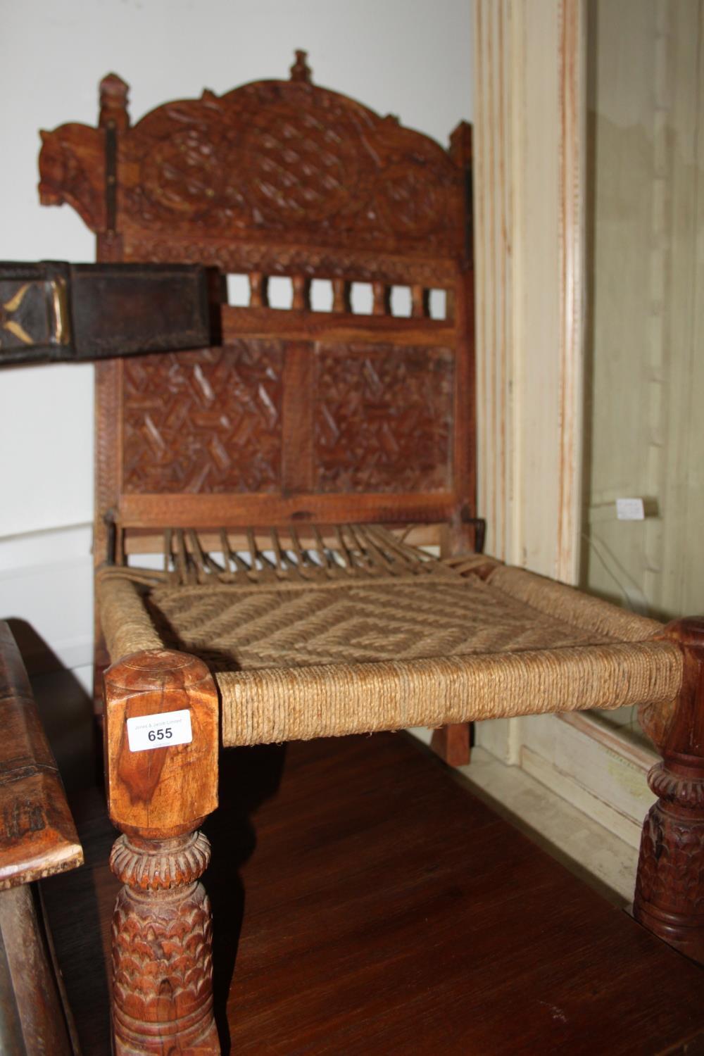 A pair of Indian sheesham low chairs with carved decorative backs and rush seats, on turned carved - Image 2 of 2