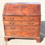 A George III figured mahogany fall front bureau, interior fitted drawers and pigeonholes over four