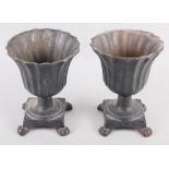 A pair of cast metal campana urns with flared rims, on square base with paw supports, 6 1/2" high