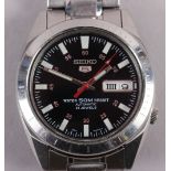 A gentleman's Seiko 5 stainless steel bracelet watch with black dial, baton and Arabic numerals, and